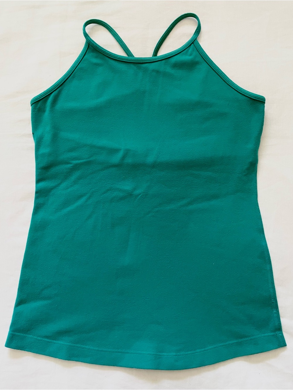 Women’s sport top. Teal green. Stretching. Size M